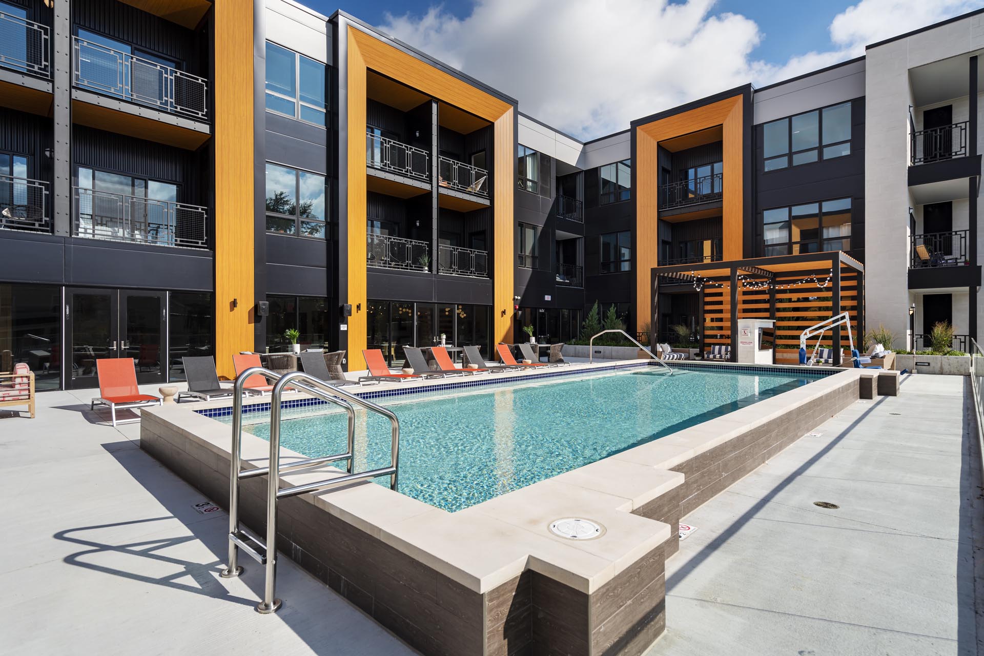 Pool outdoor pool with sundeck surrounded by the apartment building